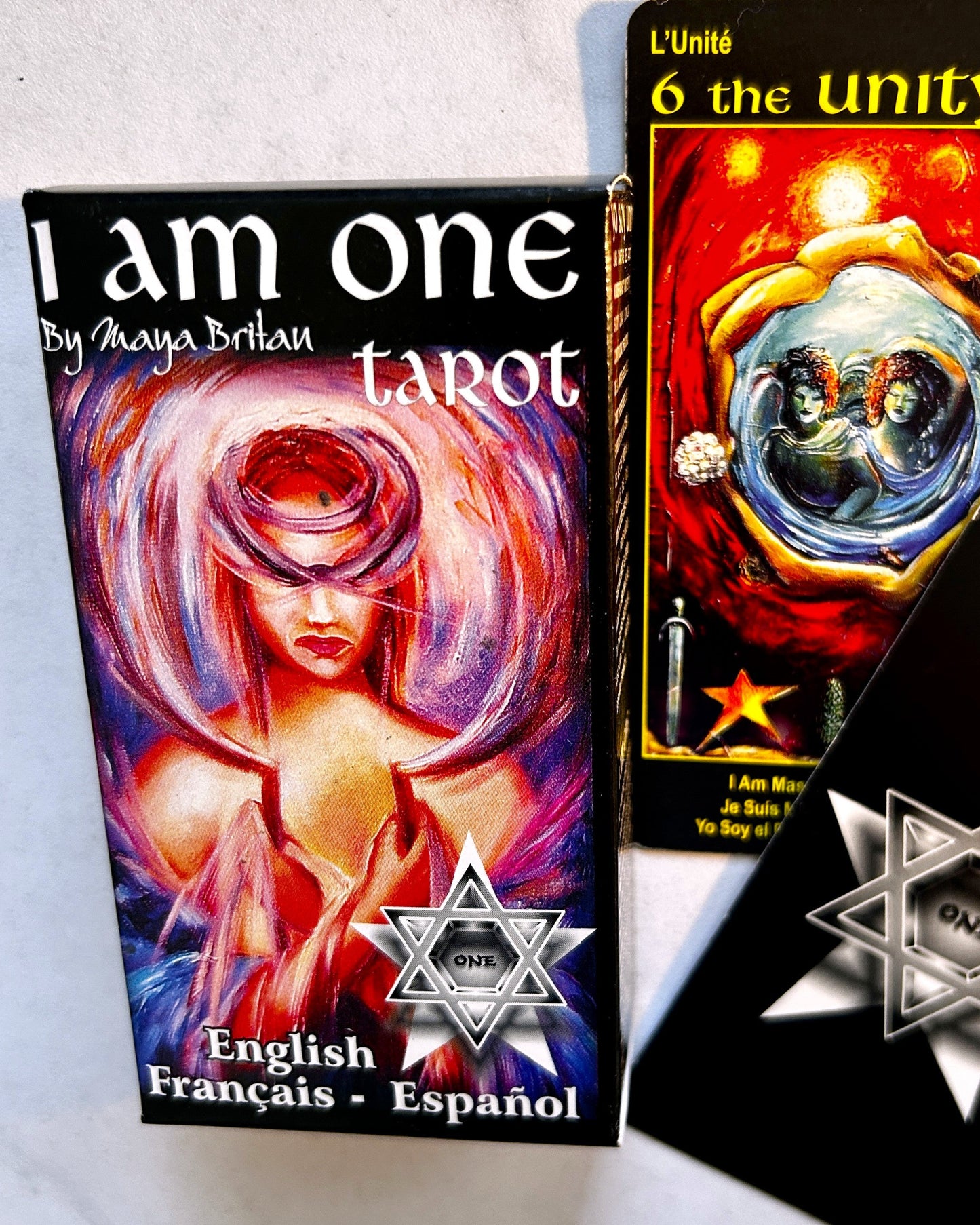 I am one tarot book and tarot card with a star symbol on a white background