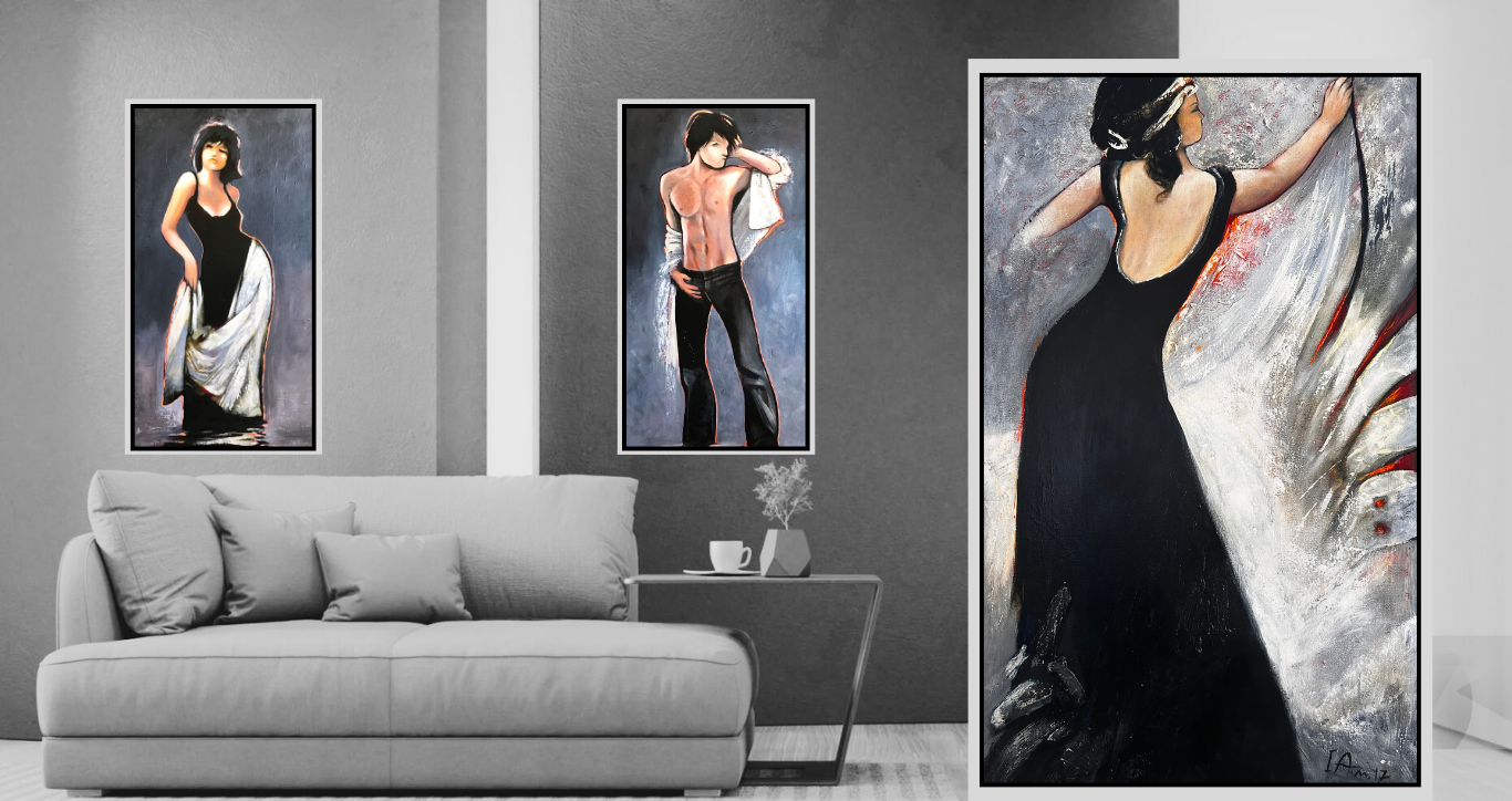 Three artistic figures displayed on a wall above a gray sofa.