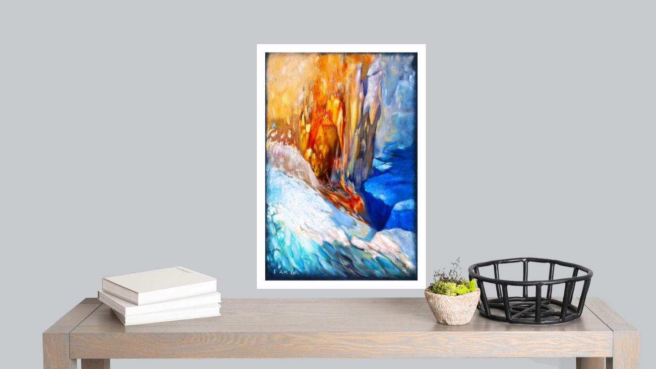 Framed abstract painting on a wooden table with books and a plant.