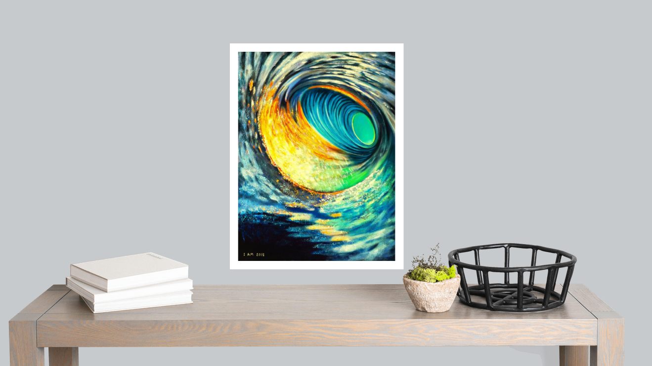 Framed abstract artwork on a table with books and a basket against a gray wall