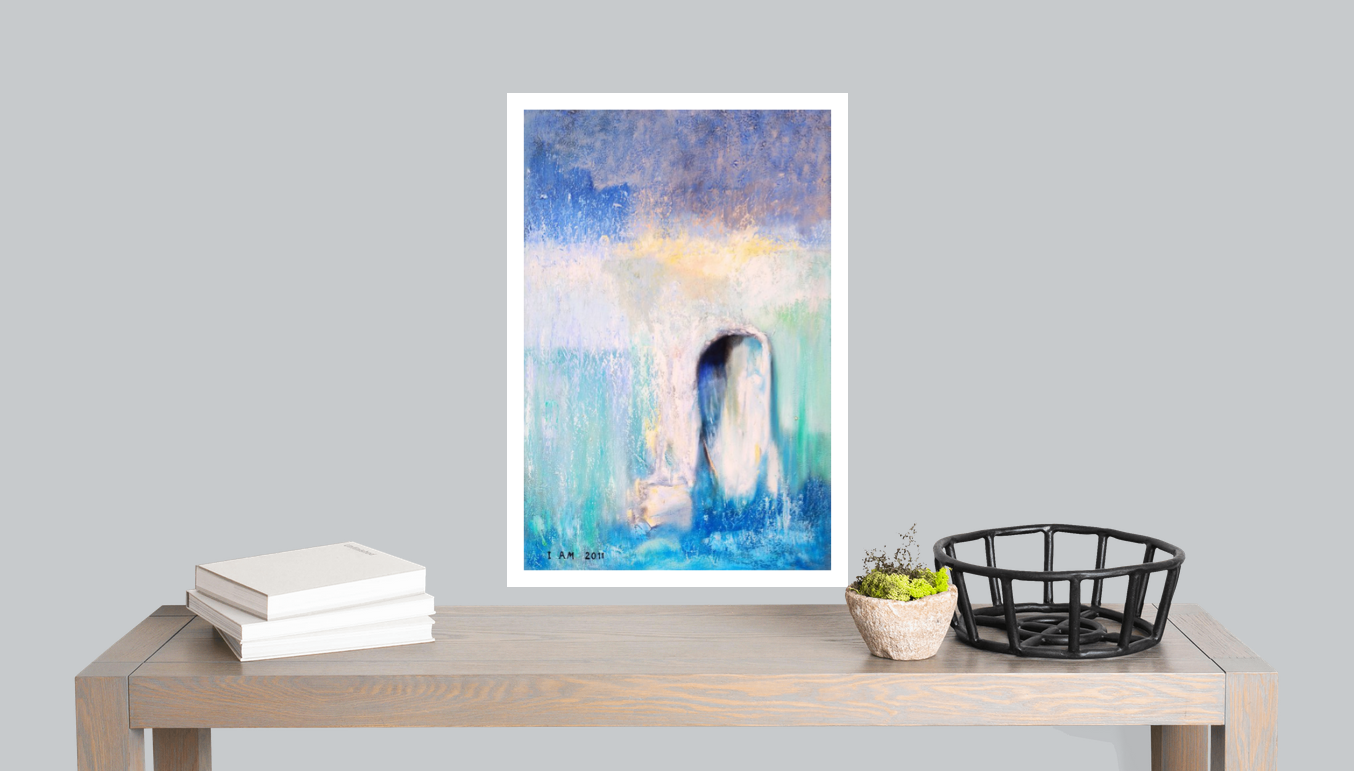 abstract artwork print with white border over a table with bonks plant and a basket
